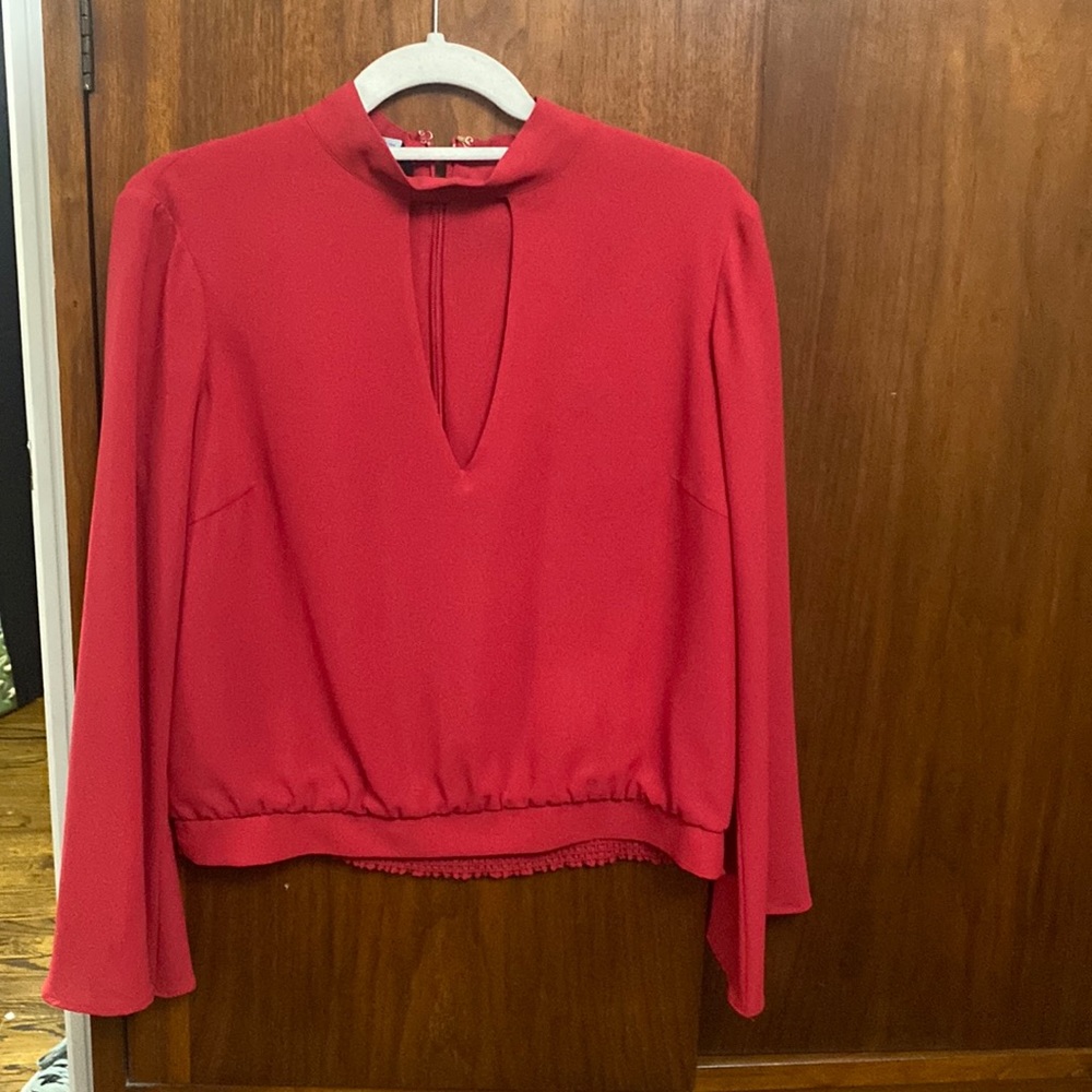 Cranberry color blouse with front keyhole and zip up back.